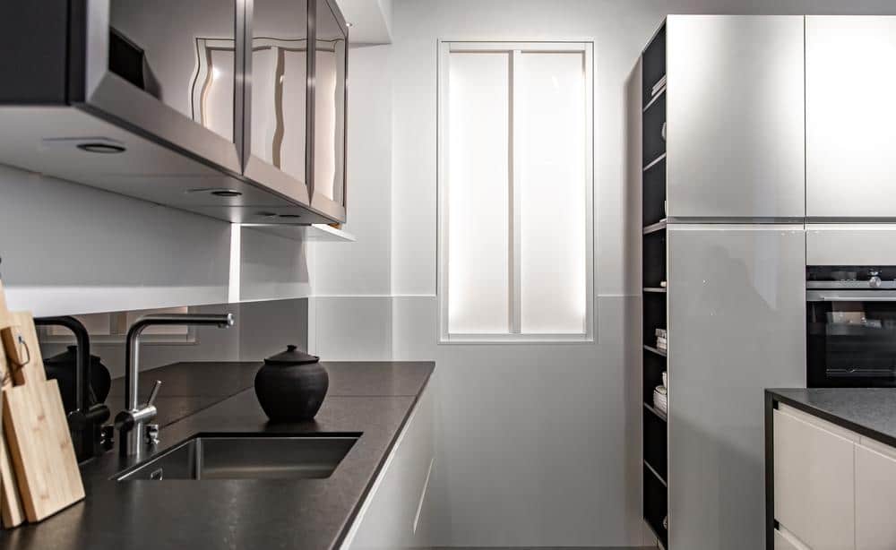 modern kitchen handle free cabinets in a narrow kitchen with black counter