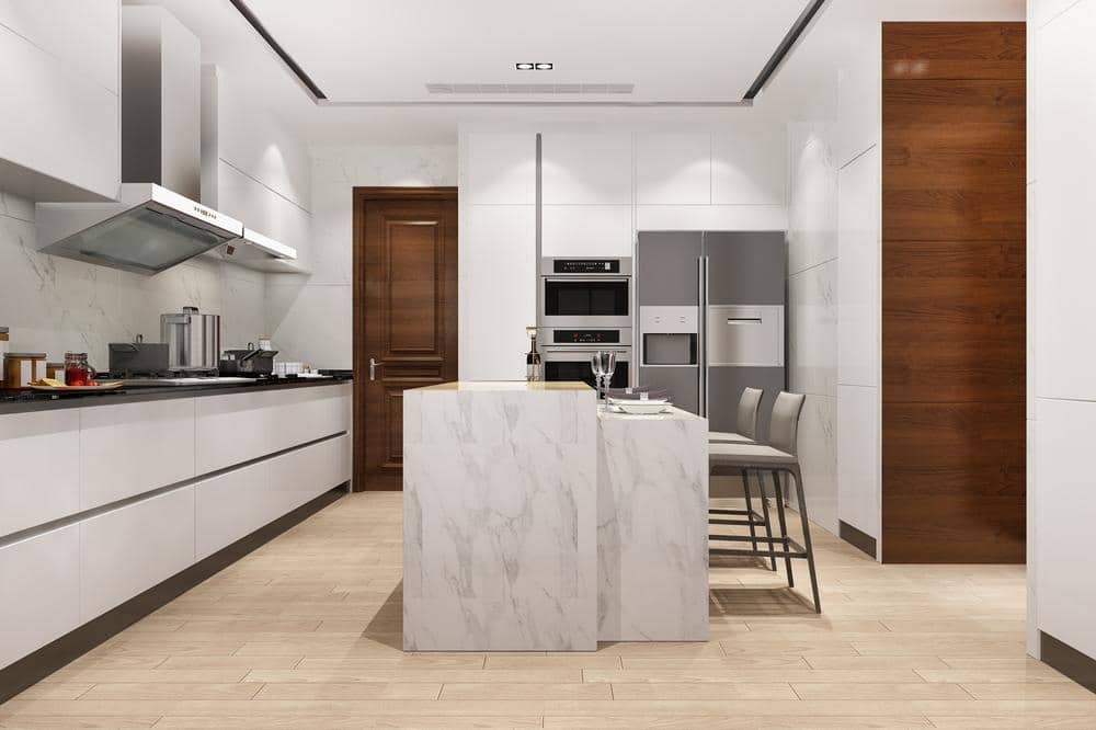 wooden floor kitchen with white handleless cabinets and marble island in the middle