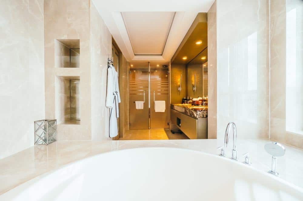 master bathroom with a hot tub and yellow led lighted interior