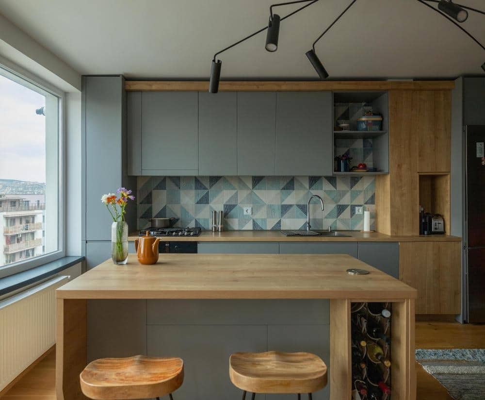 grey and wooden island in a kitchen with grey cabinets