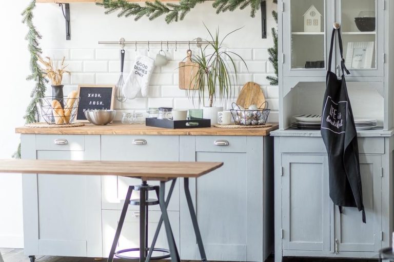 Blog 15 a kitchen with white cabinets and a wooden table.
