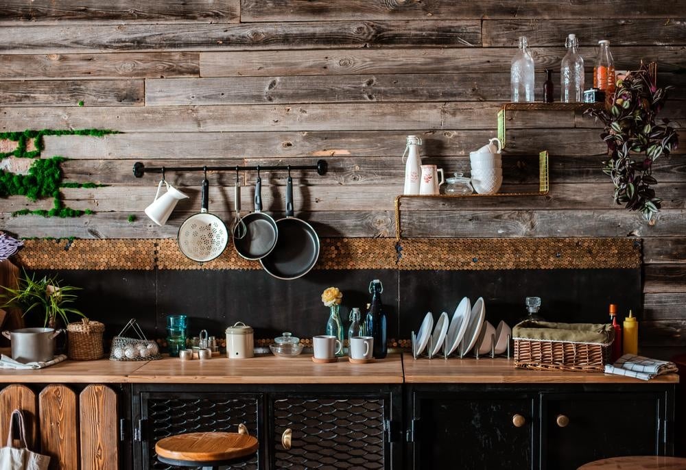 rustic wooden kitchen counter with open shelves on the wall