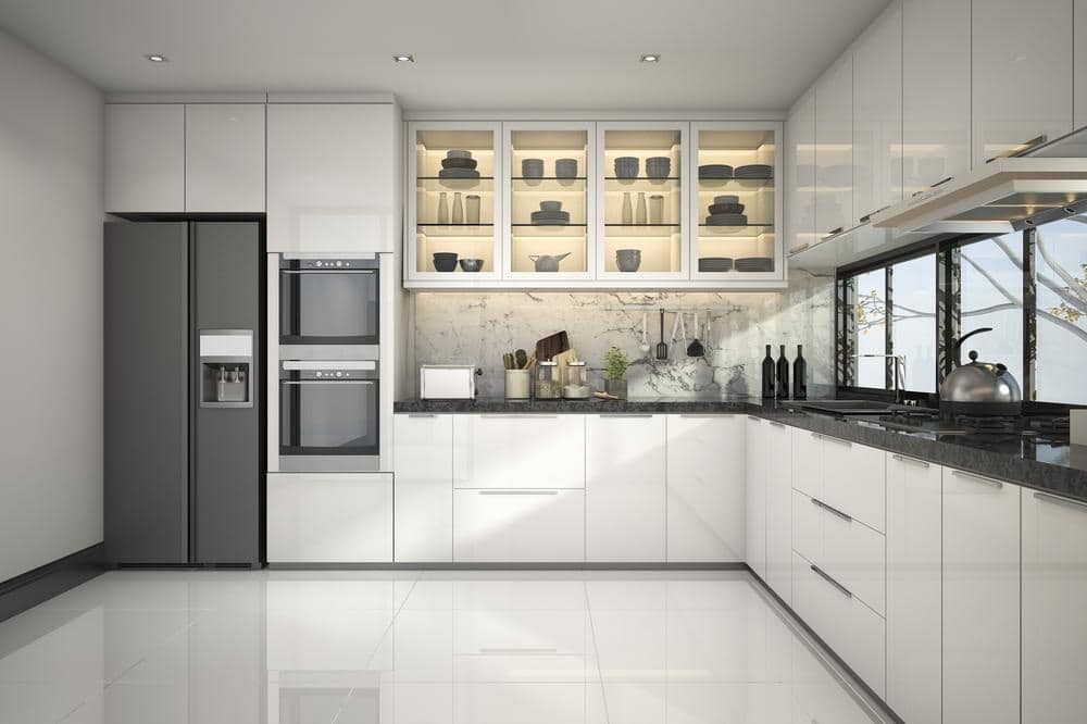 simple kitchen design that has white cabinets dark fridge and windows behind the counter