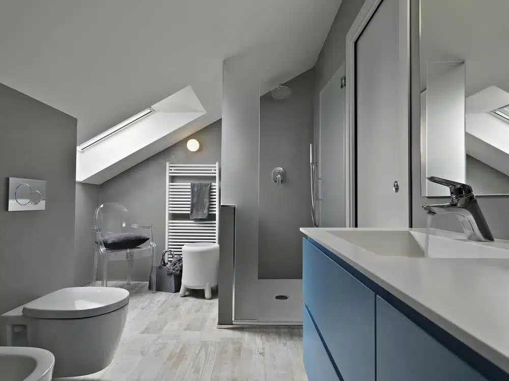 bathroom with blue vanity and grey interior