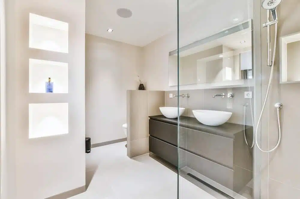 white small modern bathroom with glass shower area