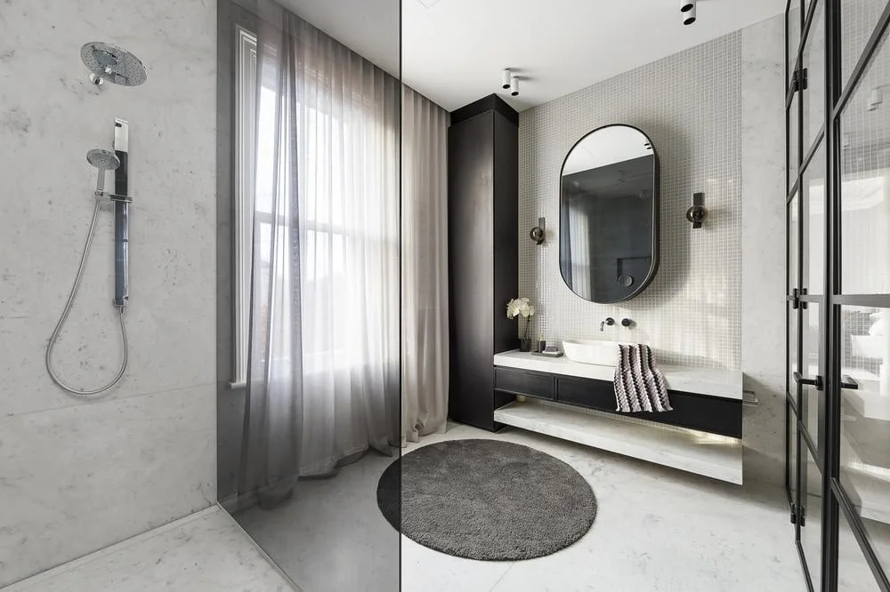 modern bathroom with glass shower and dark curtains