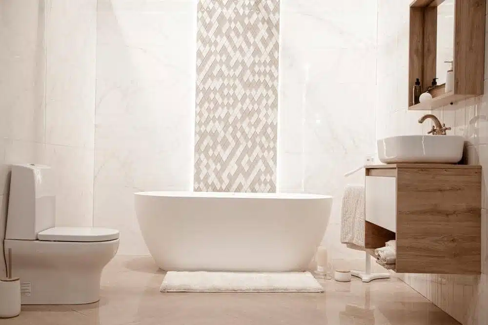 white bathroom with accent tiles on the wall