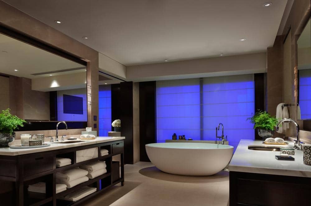 large modern bathroom with double vanities and a bathtub