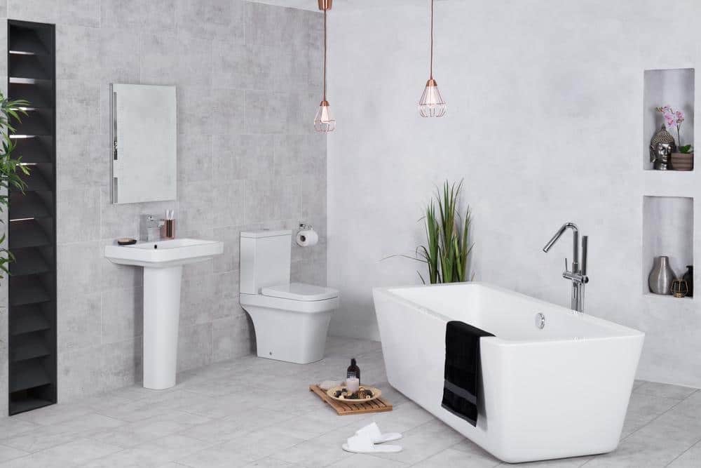 small bathroom in a marble tiled corner of a room
