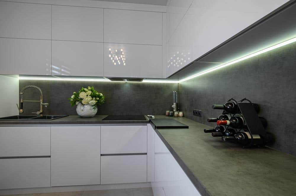 black and white kitchen counter with track lighting over the counter