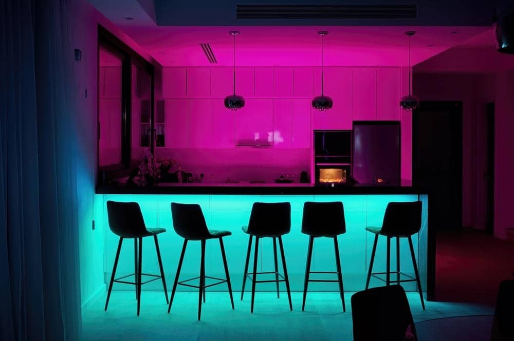 kitchen lighted with blue and pink lights in the night