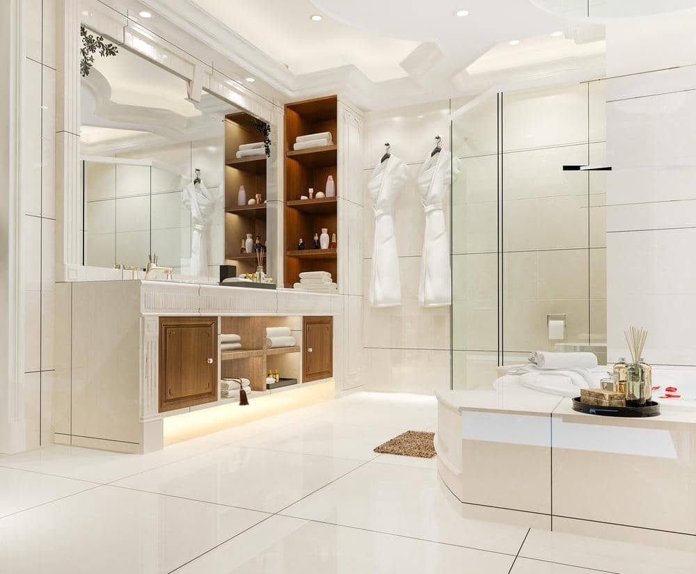 well lighted modern white bathroom with ceramic tiles and a bath tub