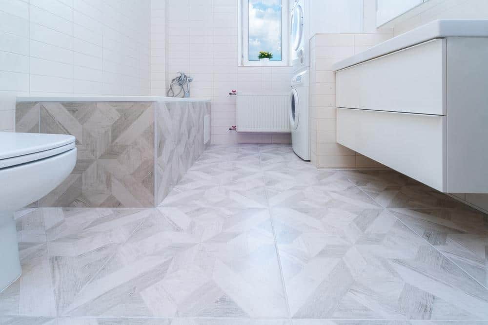 bathroom white floor tile with white cabinets and vanity