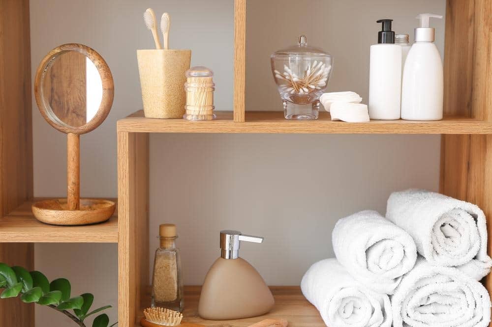wooden bathroom shelves with towels and utensils