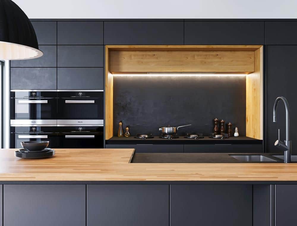 modern kitchen with black built in kitchen cabinets that has led lightings